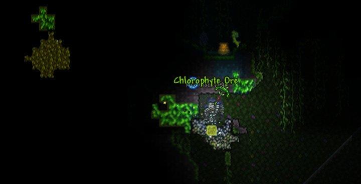 A screenshot of a Terraria world, showing a large area of the jungle biome, with a chlorophyte ore deposit near the center.